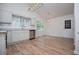 Kitchen with stainless steel appliances, white cabinets, and wood-look flooring at 9691 Squirrel Wood Run, Douglasville, GA 30135