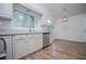 Kitchen with stainless steel appliances, white cabinets, and wood-look flooring at 9691 Squirrel Wood Run, Douglasville, GA 30135