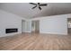 Bright living room with vaulted ceilings, modern fireplace, and wood-look laminate flooring at 9691 Squirrel Wood Run, Douglasville, GA 30135