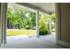 Inviting covered porch with sturdy support columns, concrete floor, and views of the green front yard at 9691 Squirrel Wood Run, Douglasville, GA 30135