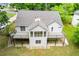 Back exterior of the house showing the deck, patio, and backyard at 9691 Squirrel Wood Run, Douglasville, GA 30135
