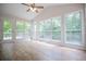 Bright sunroom with vaulted ceilings, fan, and multiple large windows at 9691 Squirrel Wood Run, Douglasville, GA 30135