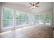 Relaxing sunroom with natural light from multiple windows and a door to the outdoor deck at 9691 Squirrel Wood Run, Douglasville, GA 30135