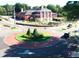 An aerial view of a brick roundabout near a building with green trees, and parked cars at 1932 Appian Aly, Kennesaw, GA 30144