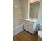 Well-lit bathroom with shower and bath combo, modern fixtures and white vanity at 1932 Appian Aly, Kennesaw, GA 30144