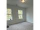 Carpeted bedroom with two windows offering lots of natural light at 1932 Appian Aly, Kennesaw, GA 30144