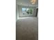 Bright bedroom features neutral carpeting, large window, and a ceiling light fixture at 1932 Appian Aly, Kennesaw, GA 30144