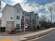 New townhome community with modern architecture and professionally landscaped entrance featuring attractive signage and gated entry at 1932 Appian Aly, Kennesaw, GA 30144