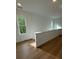 Upstairs hallway features wood floors, white walls and trim, and natural light at 1932 Appian Aly, Kennesaw, GA 30144