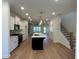 Modern kitchen with white cabinets, stainless steel appliances, a central island, and hardwood floors at 1932 Appian Aly, Kennesaw, GA 30144