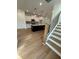 Open floor plan with kitchen and staircase with wood flooring and white cabinets at 1932 Appian Aly, Kennesaw, GA 30144