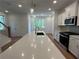 Bright kitchen featuring a large island, modern appliances, and a view of the backyard at 1932 Appian Aly, Kennesaw, GA 30144