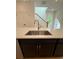 Modern kitchen with black island, white countertop, stainless steel sink and pendant lighting near staircase at 1932 Appian Aly, Kennesaw, GA 30144