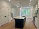 Modern kitchen with a central island, pendant lighting, stainless steel appliances, and hardwood floors at 1932 Appian Aly, Kennesaw, GA 30144
