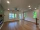 Bright, open-concept living room with hardwood floors, a modern ceiling fan, and a cozy fireplace feature at 1932 Appian Aly, Kennesaw, GA 30144