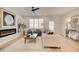 Cozy living room boasts a fireplace, neutral decor, ceiling fan and natural light at 1932 Appian Aly, Kennesaw, GA 30144