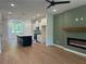 Open-concept living room with a modern fireplace and seamless flow into the adjacent kitchen at 1932 Appian Aly, Kennesaw, GA 30144