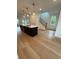 Open-concept living room with hardwood floors, a modern island, and a staircase with wooden handrails at 1932 Appian Aly, Kennesaw, GA 30144