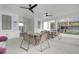 An outside eating area by the pool with multiple tables and chairs underneath a ceiling with fans at 1932 Appian Aly, Kennesaw, GA 30144