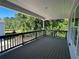 Covered porch with a wooded view provides a peaceful spot for outdoor relaxation at 1932 Appian Aly, Kennesaw, GA 30144