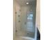 Modern bathroom featuring a glass shower with a white-tiled interior and a built-in shower bench at 1932 Appian Aly, Kennesaw, GA 30144