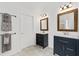 Bathroom featuring double vanities with framed mirrors and modern fixtures at 238 Ivy Glen Cir, Avondale Estates, GA 30002