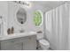 Bright bathroom featuring a vanity with storage, a toilet, and a shower with curtain at 238 Ivy Glen Cir, Avondale Estates, GA 30002