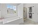 Bright bathroom featuring a large soaking tub, a separate shower, and marble floors at 238 Ivy Glen Cir, Avondale Estates, GA 30002