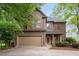 Charming two-story home features brown siding, red shutters and a two car garage at 238 Ivy Glen Cir, Avondale Estates, GA 30002