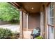 Cozy front porch with view of driveway, decorative pillars, and seating area at 238 Ivy Glen Cir, Avondale Estates, GA 30002