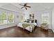 Spacious main bedroom with tray ceiling, hardwood floors, and large windows at 238 Ivy Glen Cir, Avondale Estates, GA 30002