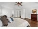 Bright main bedroom featuring wood floors, a ceiling fan, and a tray ceiling at 238 Ivy Glen Cir, Avondale Estates, GA 30002