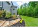 Landscaped backyard with stone steps and lush greenery provides a serene outdoor space at 3755 Valleyway Rd, Cumming, GA 30040