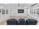Finished basement with custom built-in shelving, beamed ceiling, and entertainment space at 3755 Valleyway Rd, Cumming, GA 30040