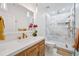 Elegant bathroom featuring a wooden vanity, quartz countertop and a luxurious walk-in shower at 3755 Valleyway Rd, Cumming, GA 30040