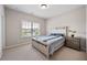 Cozy bedroom with neutral tones, a comfortable bed, and natural light from the window at 3755 Valleyway Rd, Cumming, GA 30040