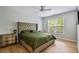 Serene bedroom with hardwood floors, a statement headboard, and ample natural light at 3755 Valleyway Rd, Cumming, GA 30040