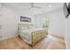 Bright bedroom with hardwood floors, large window, and simple decor at 3755 Valleyway Rd, Cumming, GA 30040