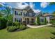 Charming home featuring a beautifully landscaped yard, manicured shrubs, and a welcoming walkway at 3755 Valleyway Rd, Cumming, GA 30040