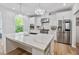 Bright kitchen features a large island, stainless steel appliances, and stylish pendant lighting at 3755 Valleyway Rd, Cumming, GA 30040