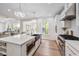 Open kitchen with stainless steel appliances, a large island, and hardwood floors at 3755 Valleyway Rd, Cumming, GA 30040