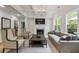 Bright and airy living room featuring a fireplace, coffered ceiling, and large windows at 3755 Valleyway Rd, Cumming, GA 30040
