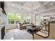 Bright living room with large windows, hardwood floors, fireplace, and open layout to the kitchen at 3755 Valleyway Rd, Cumming, GA 30040