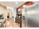 Modern kitchen with stainless steel appliances and breakfast bar extends to a cozy hallway at 400 W Peachtree Nw St # 2614, Atlanta, GA 30308