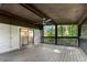 Back porch with a ceiling fan and a screen overlooking a large backyard with woods at 2100 Stone Hollow Ct, Marietta, GA 30062