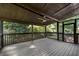 Spacious screened back porch with ceiling fan and dark railings overlooking backyard at 2100 Stone Hollow Ct, Marietta, GA 30062