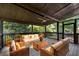 Screened back porch with neutral-colored seating and view of the surrounding yard at 2100 Stone Hollow Ct, Marietta, GA 30062