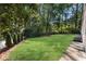 Sprawling backyard featuring luscious green grass and neatly trimmed shrubbery at 2100 Stone Hollow Ct, Marietta, GA 30062
