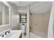 Cozy bathroom featuring white tile floors, tub/shower and views to the yard at 2100 Stone Hollow Ct, Marietta, GA 30062