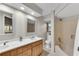 Bright bathroom featuring a double vanity, decorative mirrors, and a tiled shower/tub at 2100 Stone Hollow Ct, Marietta, GA 30062